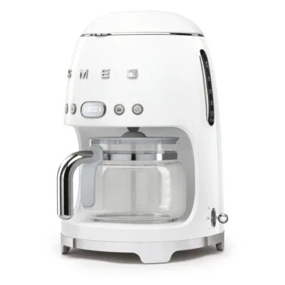 White SMEG drip coffee maker with glass carafe and retro design